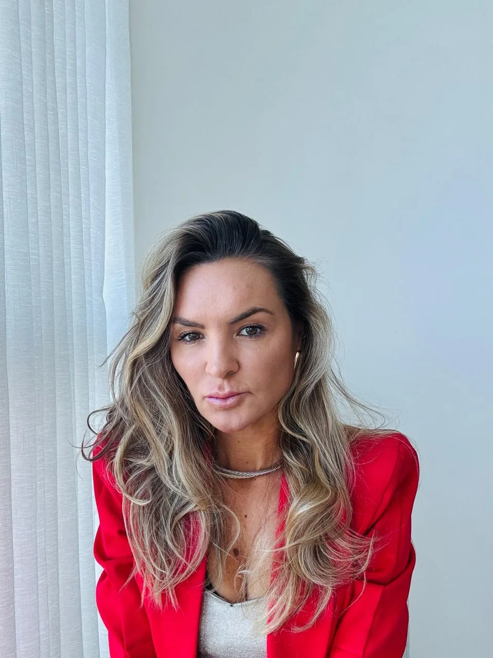 Brianna Pelegrini in a red blazer, executive portrait